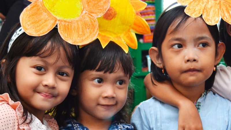 Young children receiving help from the Tanoto Foundation